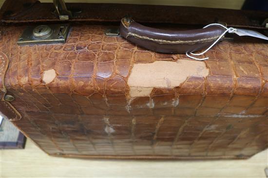 An early 20th century crocodile skin briefcase and a suitcase length 49cm